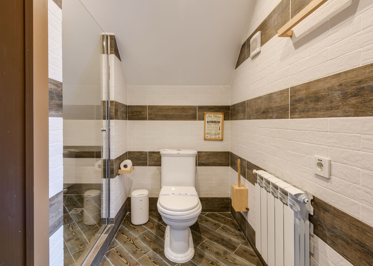 A panel radiator fitted in a tiled bathroom