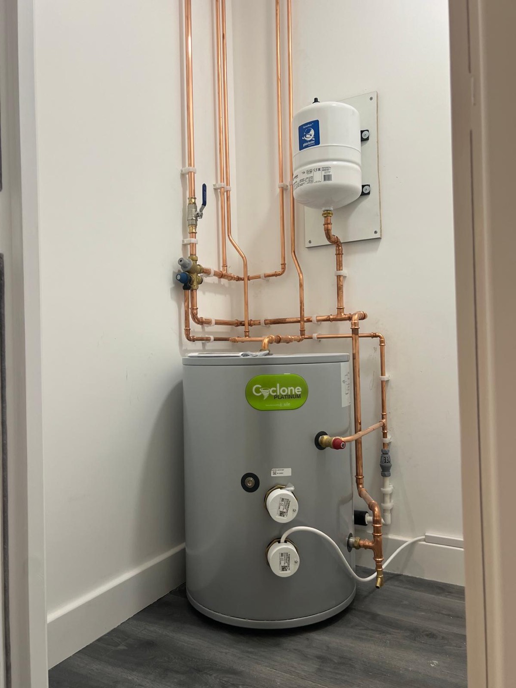 An unvented hot water cylinder installed with new copper pipework